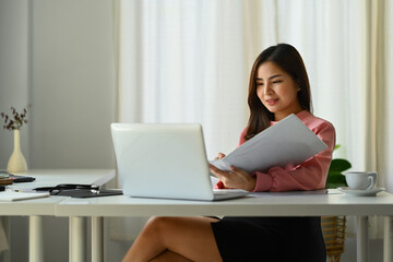 Beautiful asian businesswoman using laptop working on new startup project at her office