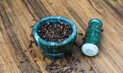Dried Cloves in a mortar and pestle for making spices 