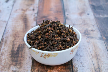 Dried Cloves in a bowl close-up view 