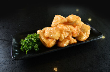 cold mixed raw vegetables,  beancurd, mushroom, carrot, noodle, tofu, lotus, corn in plate for steam boat hot pot ingredient on black marble table asian halal food cuisine menu for restaurant