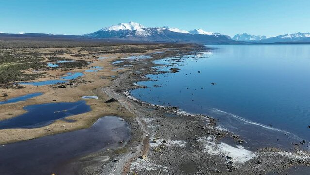 Patagonia Lake At Puerto Natales In Ultima Esperanza Chile. Snowy Mountains. Lake Landscape. Ultima Esperanza Chile. Winter Background. Patagonia Lake At Puerto Natales In Ultima Esperanza Chile.