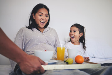 Surprise, breakfast and mother with child in bed relaxing on weekend morning at their home. Happy,...