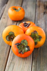 persimmons on wooden table