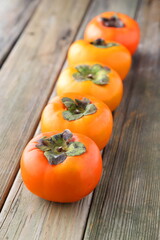 persimmons on wooden table