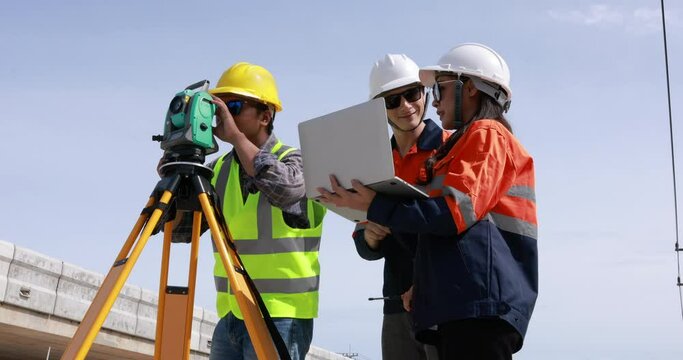 Engineer use theodolite equipment and looking blueprints  project on laptop for route surveying to build a bridge across the intersection to reduce traffic congestion during rush hours. 4k video