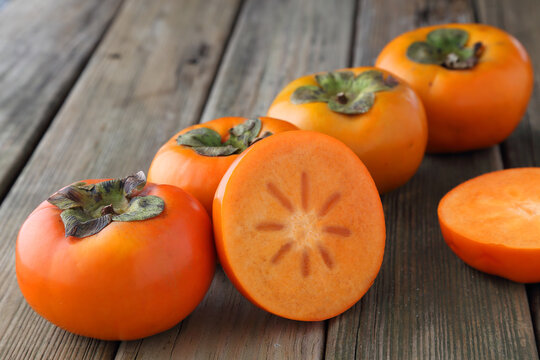 persimmons on wooden table