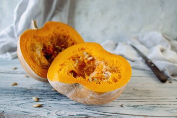 Pumpkin slices with seeds on wooden background, selective focus