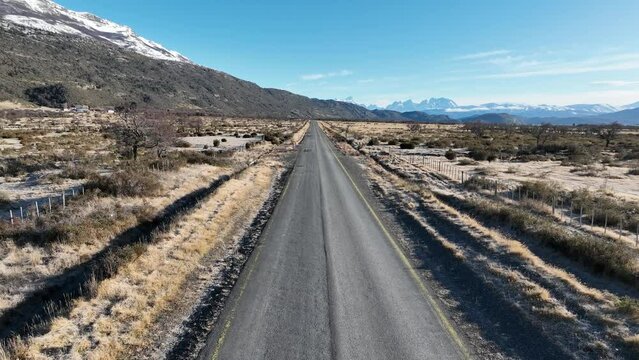 Single Road At Puerto Natales In Ultima Esperanza Chile. Snowy Mountains. Road Landscape. Ultima Esperanza Chile. Winter Background. Single Road At Puerto Natales In Ultima Esperanza Chile.