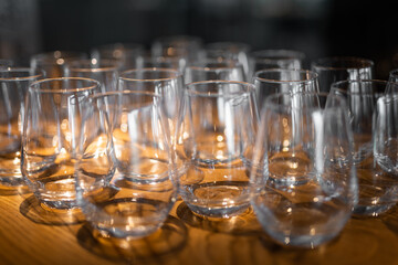 empty clean glass glasses for alcoholic drinks in a restaurant on a bar counter