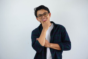 smiling young asian man happiness face with his hand on chin isolated on white background.