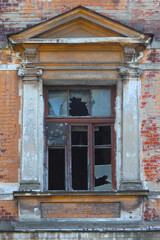 Window with broken glass in an old house.
