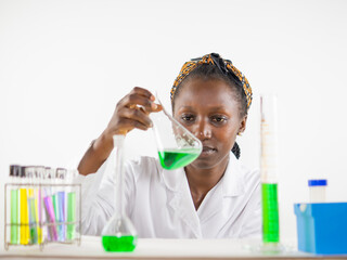  Young female scientist keenly observing a sample in an erlenmeyer flask inside a laboratory