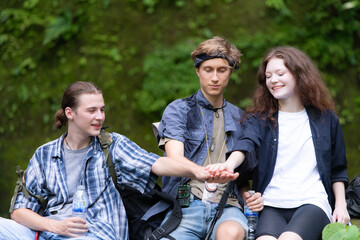 Group of young people hiking in the forest. Travel and adventure concept.