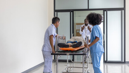 An African doctor is checking an unconscious female elderly patient when rescuer brings her to the emergency room