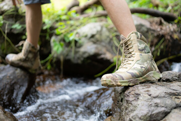 Hiking shoes on a log or rocks in the forest.