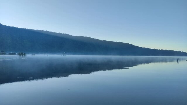 Landscape with morning fog in the Beratan lake, Tabanan, Bali.