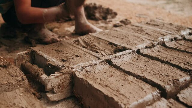 Clay bricks making traditional method in Central Asia. Handmade work. craft. Problem of using the labor of minor children