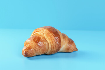Croissant with a blue background.