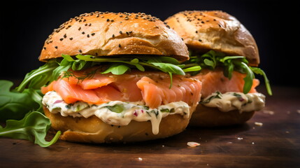 two salmon lox bagels with rocket and dill cream cheese isolated on black background