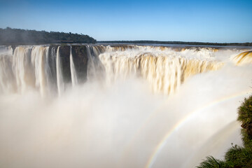 The thunderous Devil's throat at Iguazú Falls, one of the new seven natural wonders of the world in all its beauty viewed from a viewpoint on the Argentinian side - traveling South America 
