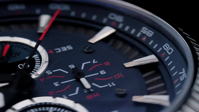 Close Up Of Stylish Luxury Man Wrist Watch With Moving Hand And Multiple Dials. Men's chronograph watch in metal with sapphire crystal. closeup view of rotating watch, running second arrow. blue dial