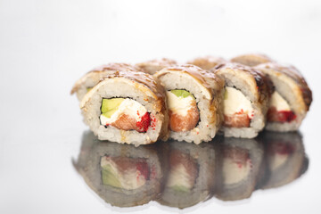 Sushi roll with smoked eel, salmon, avocado, Philadelphia cheese on white background. Sushi menu. Japanese food concept.