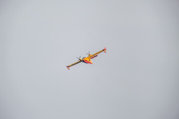 SANTA CRUZ DE TENERIFE, SPAIN/TENERIFE -August 19 2023: Forest fires in Tenerife. Firefighting seaplane flying over the blue sky at sunset..