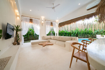 Tropical villa view with garden, swimming pool and open living room. Luxury modern villa