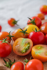 Organic chopped cherry tomatoes close up on a wooden board.