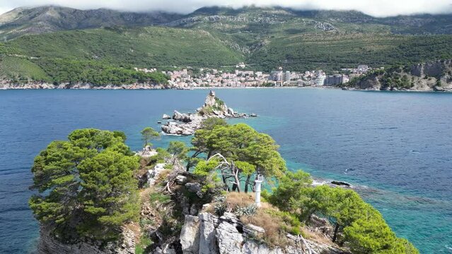 Church on the rock on Katic islet in Petrovac na Moru Aerial View. Beaches and coastline of the Adriatic Sea at summer time. Natural landscapes of Montenegro. Balkans. Europe.