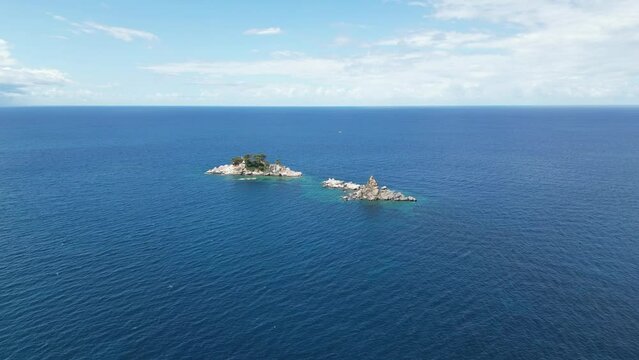 Church on the rock on Katic islet in Petrovac na Moru Aerial View. Beaches and coastline of the Adriatic Sea at summer time. Natural landscapes of Montenegro. Balkans. Europe.