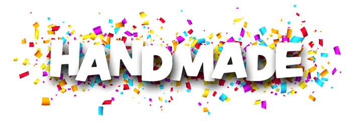 Banner with handmade sign over colorful cut out ribbon confetti background.