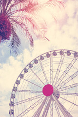 Color toned picture of a Ferris wheel against the sky, color toning applied.