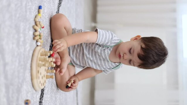 baby boy playing at home wooden memory matchstick chess game, funny block board.child kid sitting on floor putting on or remove pieces.spinning board, throwing cube,colorful pieces 4k