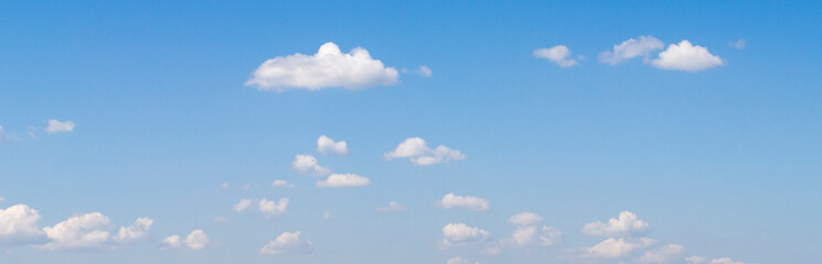 White clouds flying in deep blue summer sky