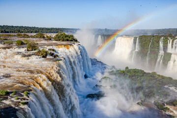 Perfect rainbow over Iguazu Waterfalls, one of the new seven natural wonders of the world in all its beauty viewed from the Brazilian side - traveling South America