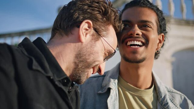 Closeup happy gays laughing talking at romantic weekend. Happy homosexual men