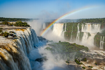 Perfect rainbow over Iguazu Waterfalls, one of the new seven natural wonders of the world in all its beauty viewed from the Brazilian side - traveling South America