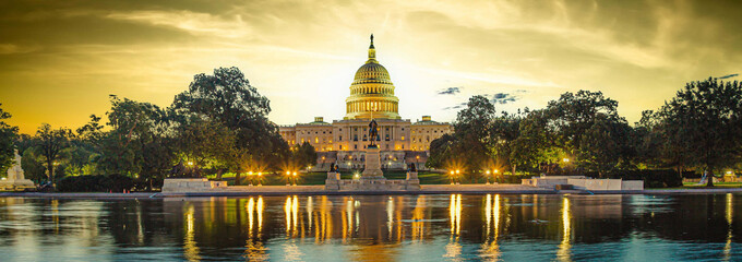Panoramic image of the Capitol of the United States with the capitol reflecting pool in morning...