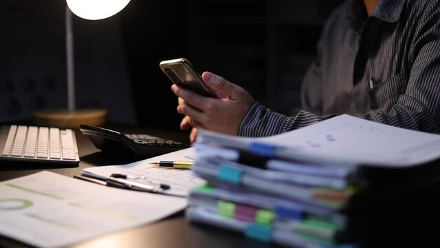 Businessman using smartphones on their desks in the office.
