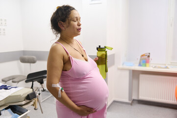 A woman in labor deep breasthing while having contractions in the hospital delivery room....