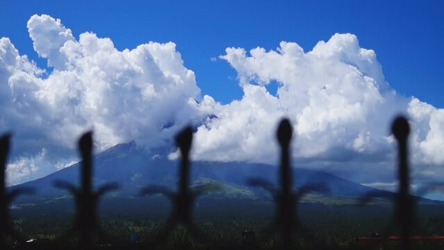 White ash clouds emit from Mayon volcano crater on a clear day. selective focus