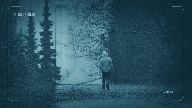 CCTV Man Walking Down Hill With Road In Distance