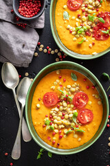 Homemade lentil soup with cream and cherry tomatoes.