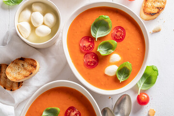 Red tomato soup made of basil and cherry tomatoes.