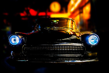 Shiny old black car with blue lights