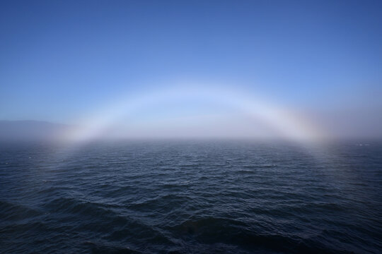 Bright fogbow in Juan de Fuca Strait off Port Angeles, Washington on sunny foggy summer morning.