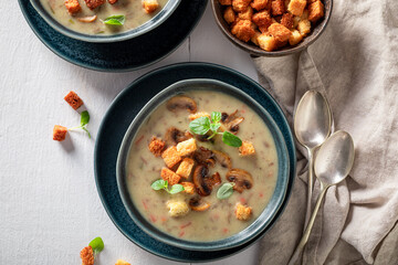Homemade mushrooms soup with champignons and croutons.