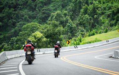 Obraz premium motorcycle on the road rides away. Travel on vacation, enjoy the nature trail. motorcycle in a sunny motorbike on the road riding.with sunset light. copyspace for your individual text. 