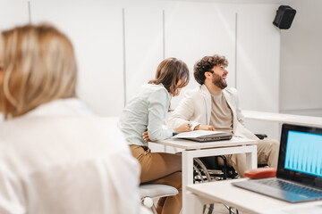 Obraz premium Handicapped male person burst out laughing after his female colleague told him a joke